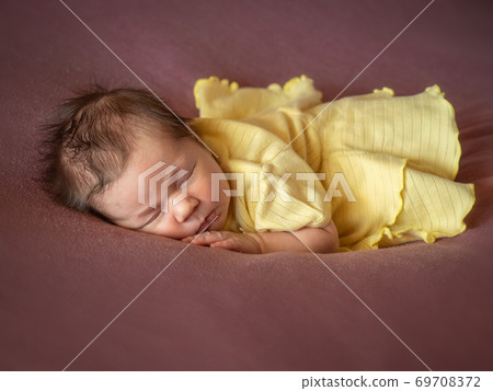 8 days old newborn baby girl sleeping in yellow dress 8 days old newborn baby girl sleeping in yellow dress 69708372