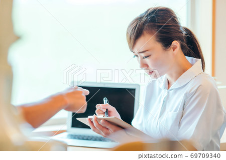 Asian female nurse and male patient Asian female nurse and male patient 69709340