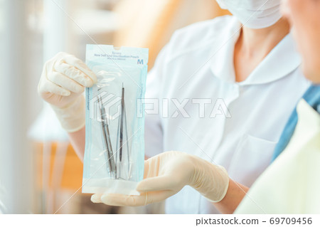 Nurse handling medical equipment Nurse handling medical equipment 69709456