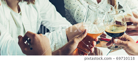 Hands of young friends, colleagues during beer drinking, having fun, laughting and celebrating together. Flyer with copyspace Hands of young friends, colleagues during beer drinking, having fun, laughting and celebrating together. Flyer with copyspace 69710118