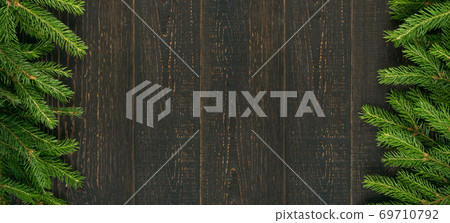 Christmas background with fir branches on wooden backdrop 69710792