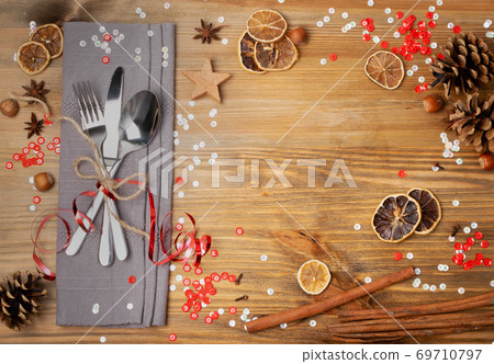 Christmas Dinner Table Setting with Cutlery and Winter Spices 69710797