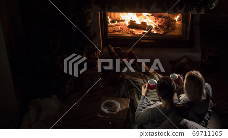 Romantic couple drinks ay by the fireplace, top view 69711105