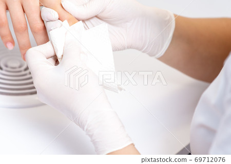 Hands wiping the nails. 69712076