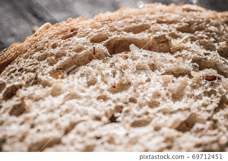 Fresh whole grain seeded bread, organic wheat flour, closeup slice texture as background for food blog or cook book recipe Fresh whole grain seeded bread, organic wheat flour, closeup slice texture as background for food blog or cook book recipe 69712451