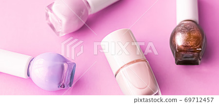 Nail polish bottles on pink background, beauty brand 69712457