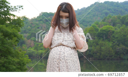 Japanese pregnant woman wearing a mask Japanese pregnant woman wearing a mask 69712857