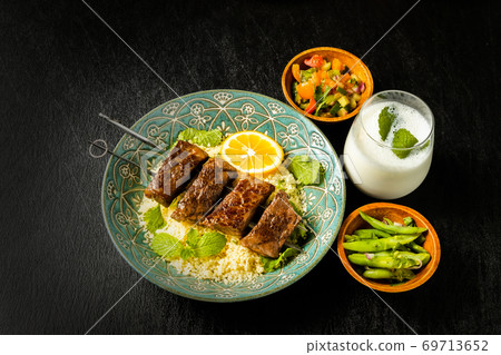 Shish kebab and couscous dishes 69713652