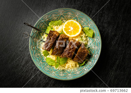 Shish kebab and couscous dishes 69713662