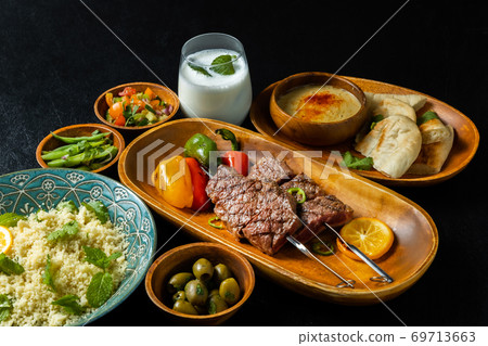 Shish kebab and couscous dishes 69713663