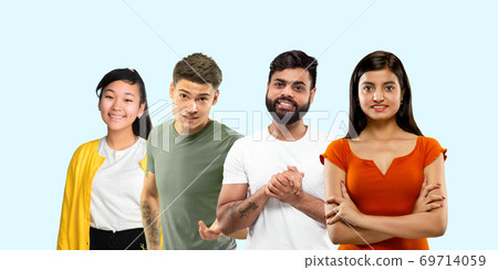 Group portrait of emotional people on blue studio background 69714059