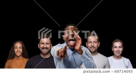 Group portrait of emotional people on black studio background 69714093