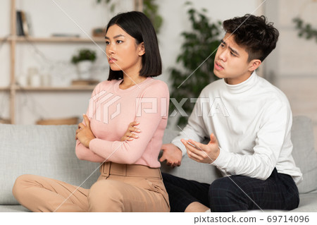 Asian Couple After Quarrel, Husband Talk To Offended Wife Indoor 69714096