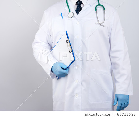 male therapist in a white medical coat, tie, a stethoscope hangs around his neck, stands on a white background 69715583