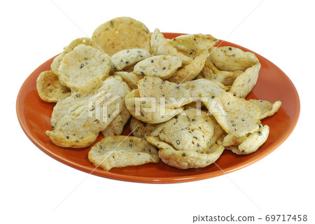 Fish crackers in plate isolated on white background Fish crackers in plate isolated on white background 69717458