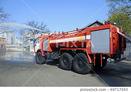 Water cannon of a firetruck shooting a high-velocity stream of water 69717893