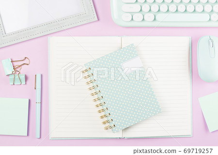 flat lay stationery on work desk in pink pastel background 69719257