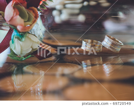 Golden wedding rings in decorative champagne glass 69720549