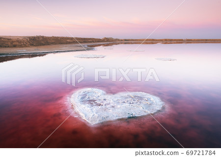 Heart from salt in pink water salt lake 69721784