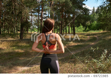 Beautiful young woman practicing yoga in the morning on the nature. 69721985