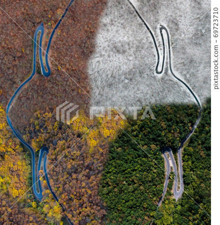 Seasons Concept summer winter fall spring Aerial view Winding road serpentine mountain pass village Brodenbach Germany 69723710