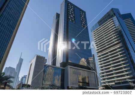 Jacht and Skyscrapers Above the Water of Persian Gulf in Dubai Marina District in UAE 69723807