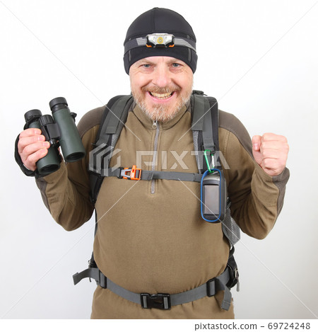 happy tourist traveler with binoculars in hand on a white background happy tourist traveler with binoculars in hand on a white background 69724248