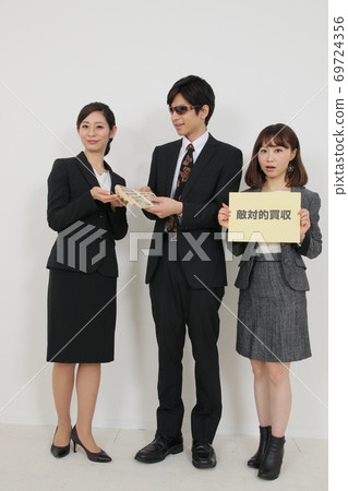 Hostile takeover business image (with a wad of bills) Hostile takeover business image (with a wad of bills) 69724356