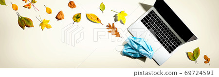 Laptop computer with masks in autumn Laptop computer with masks in autumn 69724591