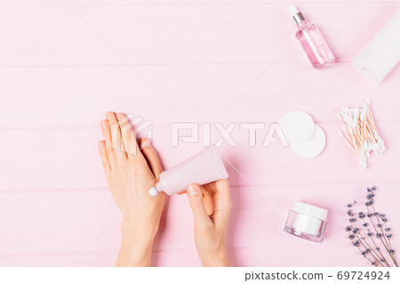Female hands apply drop of cosmetic skin care lotion Female hands apply drop of cosmetic skin care lotion 69724924