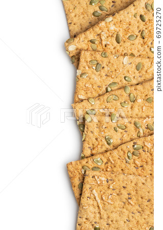 The  crispy bread with pumpkin seeds. Knackebrot on white background. 69725270