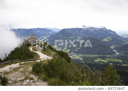 Kehlsteinhaus, Eagle Nest, Berchtesgaden in Germany, history place beautiful landscape on mountain peak with mist, cloudy background Kehlsteinhaus, Eagle Nest, Berchtesgaden in Germany, history place beautiful landscape on mountain peak with mist, cloudy background 69725647