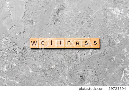 Wellness word written on wood block. Wellness text on cement table for your desing, concept 69725894