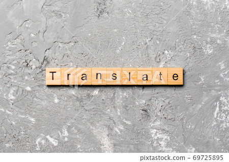 Translate word written on wood block. Translate text on cement table for your desing, concept 69725895