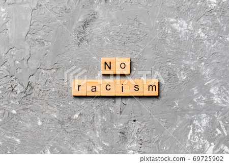 No racism word written on wood block. No racism text on table, concept No racism word written on wood block. No racism text on table, concept 69725902
