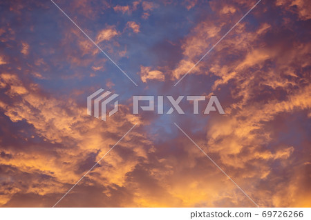 Celestial World concept. Dark orange yellow purple natural bright sunset sky cumulus clouds. Background natural color of evening cloudscape panorama. Ideal for design wallpaper 69726266