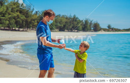 Normal reality COVID pandemic. Father ask boy put on mask protect coronavirus, son refuses does not want to constantly wear it everywhere, get tired of mask, walk nature sea beach forest park sun day Normal reality COVID pandemic. Father ask boy put on mask protect coronavirus, son refuses does not want to constantly wear it everywhere, get tired of mask, walk nature sea beach forest park sun day 69726307