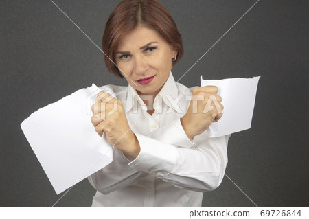 Beautiful business woman tearing white paper in half 69726844