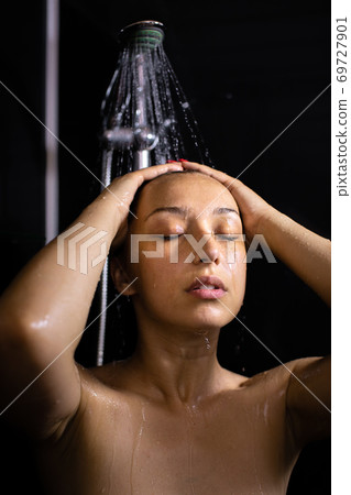 Sensual portrait of young beautiful woman taking shower, relaxation tips concept 69727901