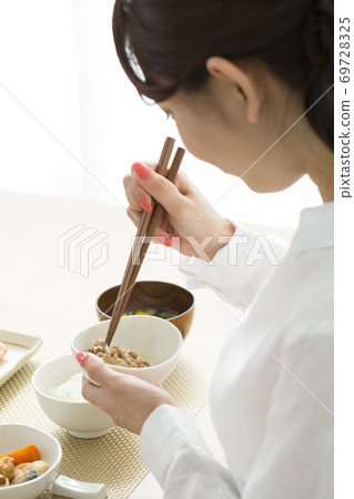 A woman mixing natto A woman mixing natto 69728325