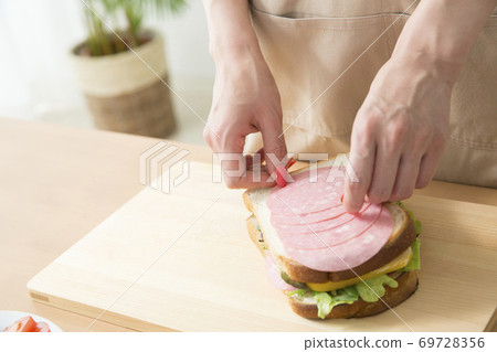 Woman making a sandwich Woman making a sandwich 69728356