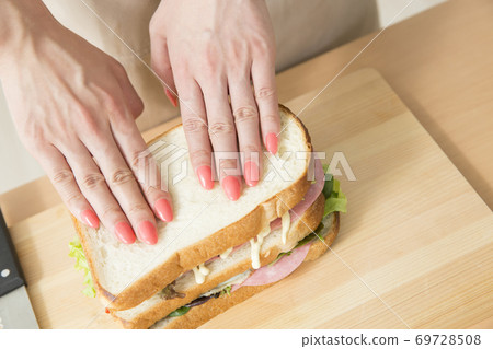 Woman making a sandwich Woman making a sandwich 69728508