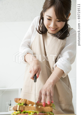 Woman cutting a sandwich 69728511