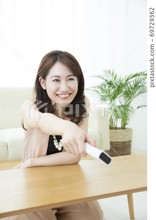 A woman watching TV A woman watching TV 69729362