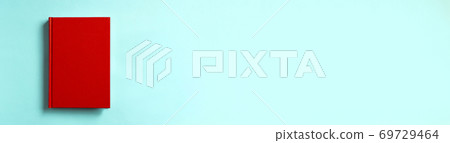 Red book on light blue background Red book on light blue background 69729464