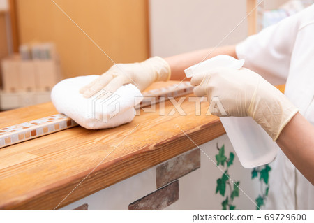 Medical staff disinfecting the reception counter Medical staff disinfecting the reception counter 69729600