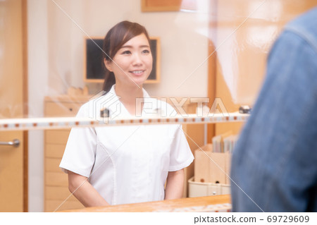 Medical staff talking over the partition Medical staff talking over the partition 69729609
