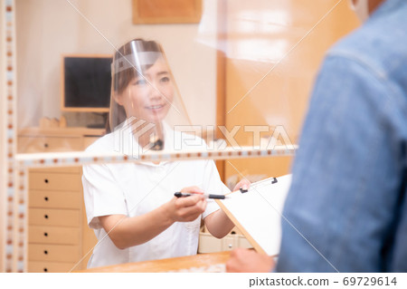 Medical staff talking over the partition Medical staff talking over the partition 69729614