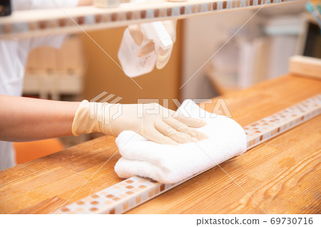 Medical staff disinfecting reception counter Medical staff disinfecting reception counter 69730716