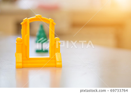 a plastic green Christmas tree, a yellow large gate for Santa Claus for the New year. isolated on a white background. copy space 69733764
